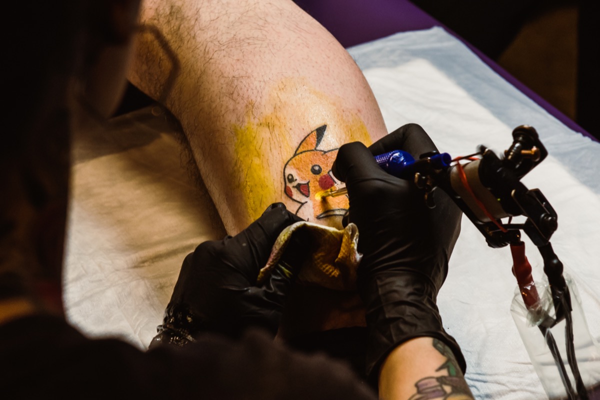 Kim Wall tattooing Pikachu.